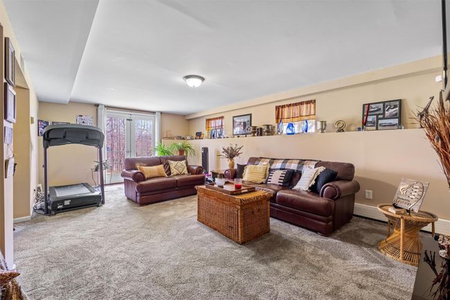 Finished basement with French doors opening up to the backyard. | Image 17