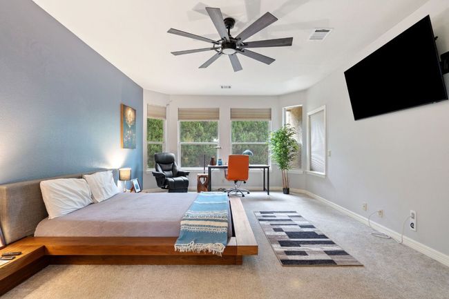 Bedroom featuring baseboards, visible vents, carpet flooring, and ceiling fan | Image 24