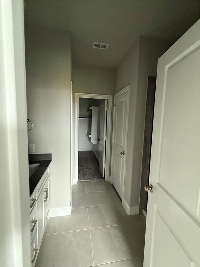 Bathroom featuring vanity, tile patterned flooring, and a closet | Image 13