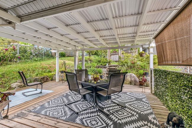 Wooden deck featuring outdoor dining space and a fenced backyard | Image 17