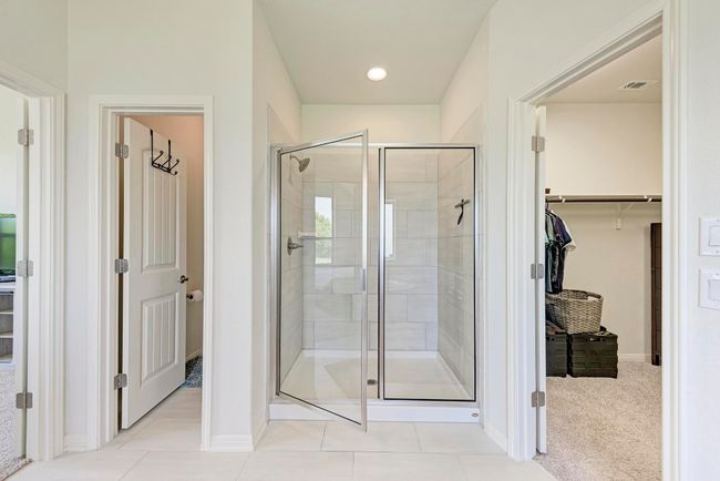 An enlarged, tile surround separate shower is conveniently adjacent to the huge walk-in closet. | Image 27