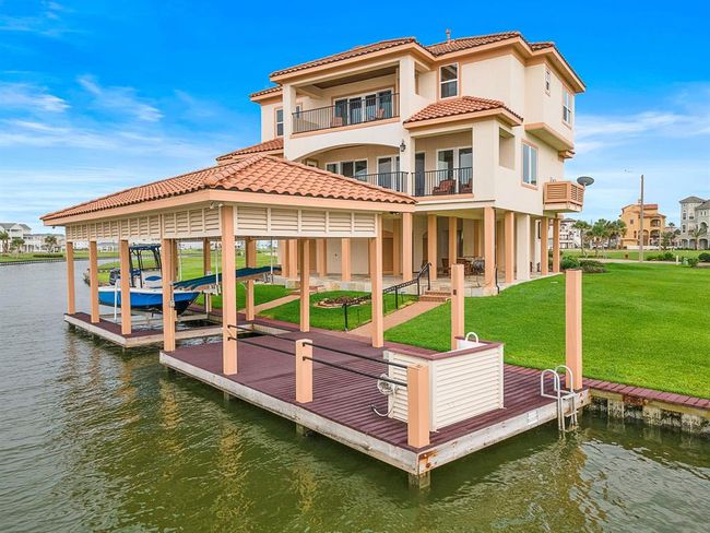 The beautifully manicured lawn, open dock area, and seamless indoor-outdoor living design make this home a rare gem in a premium waterfront setting | Image 44