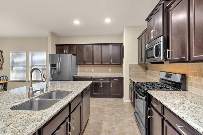 Granite counter and stainless steel appliances. | Image 19