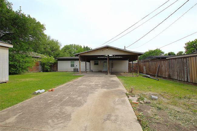 View of front of property with driveway, a fenced backyard, a front yard, and central AC unit | Image 17