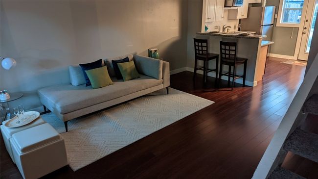 Living room featuring dark wood-style flooring and baseboards | Image 9