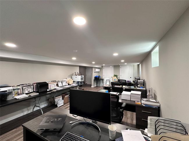 Office area with wood finished floors and recessed lighting | Image 15