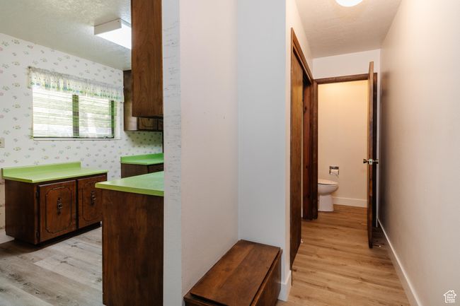 Corridor with light wood-style flooring and wallpapered walls | Image 18