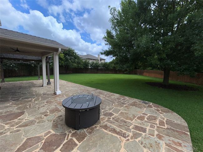 View of patio / terrace featuring an outdoor fire pit and ceiling fan | Image 26