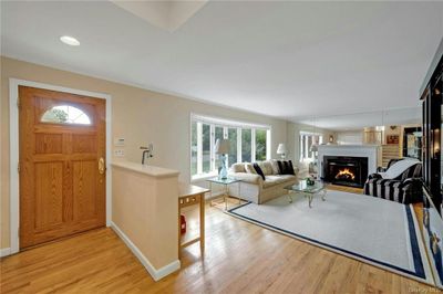 Filled with sunlight, entry foyer, open to living room, crown molding and hardwood floors throughout | Image 3