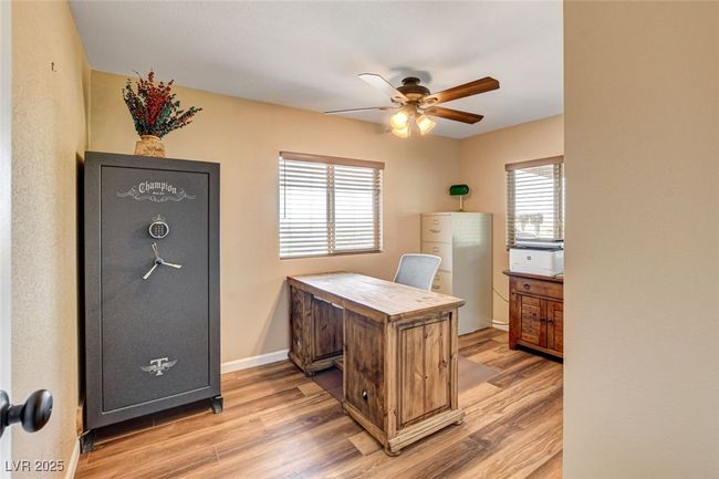 Home office featuring light wood-type flooring and a ceiling fan | Image 13