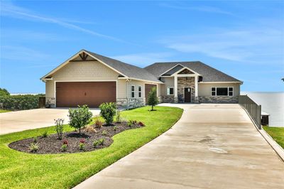 Welcome to 230 Legacy Boulevard - this stunning waterfront home is located in the gated community of Heritage Shores on Lake Livingston. | Image 1