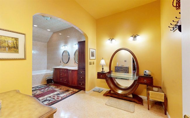 Full bath featuring a tub, vanity, tile patterned floors, and lofted ceiling | Image 43