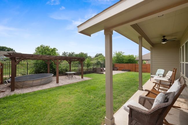 View of yard featuring a pergola, ceiling fan, a patio area, and outdoor lounge area | Image 23