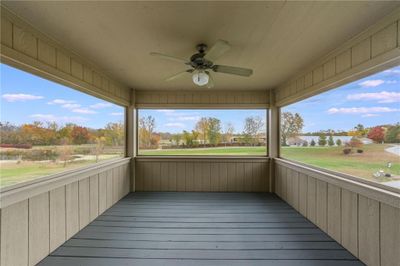 Unfurnished sunroom with ceiling fan and plenty of natural light. Overlooks the golf course and lake. | Image 3