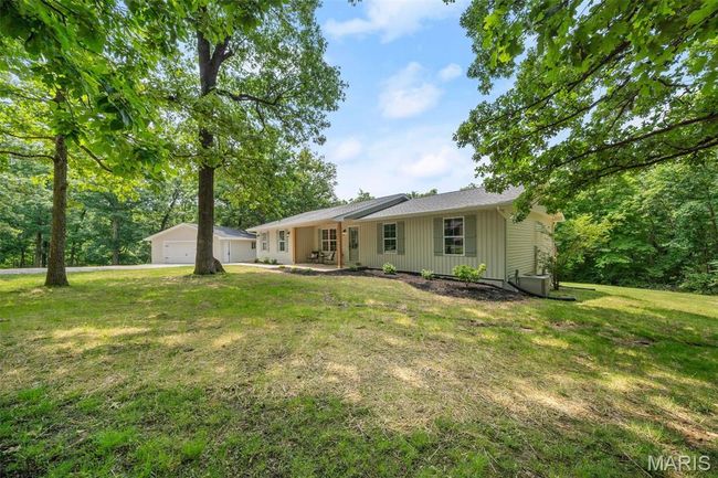 Rear view of property featuring a yard and a patio area | Image 63