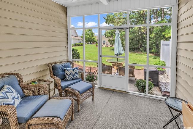Sunroom / solarium with a ceiling fan | Image 27
