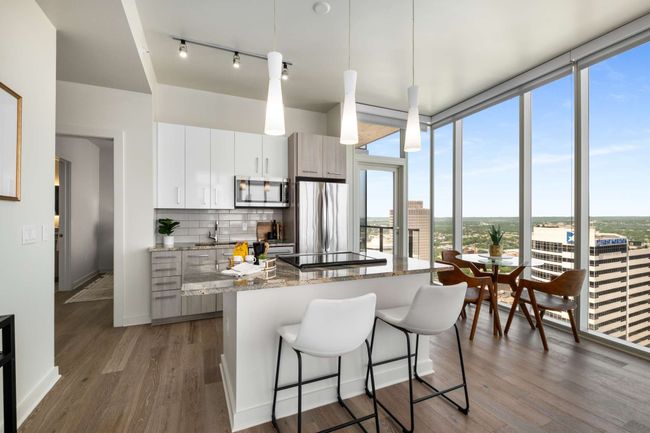Designed to optimize functionality and flexibility, multiple seating zones are created by the island and along with North-facing windows. | Image 19