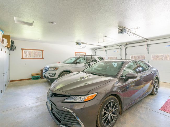 28x28 oversized heated two-car garage with 8ft tall doors. (Will ?t full-sized double-cab pickups) Lots of storage cabinets and a garage utility sink | Image 24