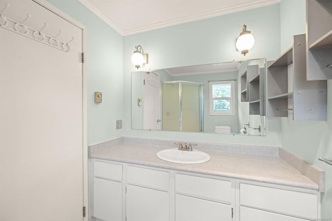 Full bath featuring ornamental molding, vanity, a shower stall, and toilet | Image 24