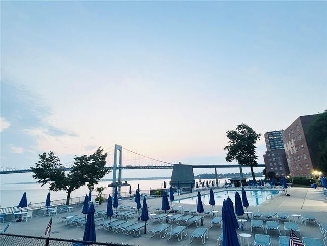 Pool at dusk featuring a water view | Image 13