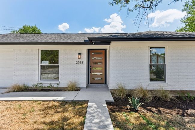 View of exterior entry featuring roof with shingles and brick siding | Image 4