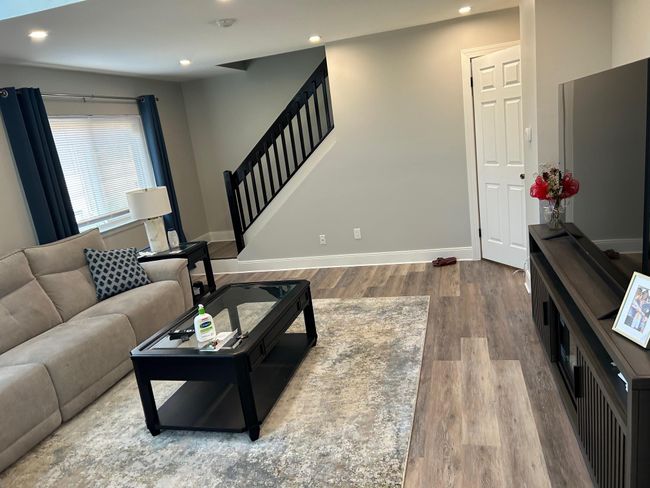 Living area featuring wood finished floors, stairway, recessed lighting, and baseboards | Image 18