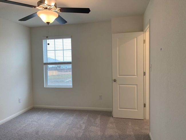 Carpeted spare room with a ceiling fan and baseboards | Image 8