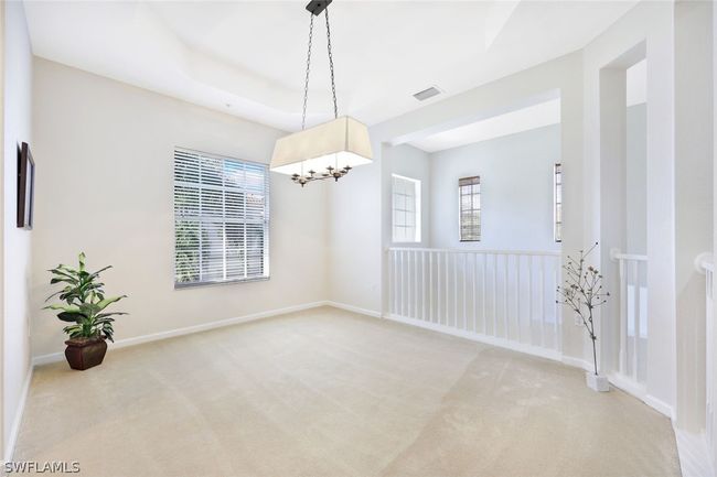 Dining room with a healthy amount of sunlight, an inviting chandelier, and carpet floors | Image 17