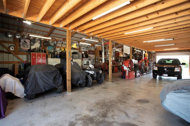 Garage with a workshop area | Image 29
