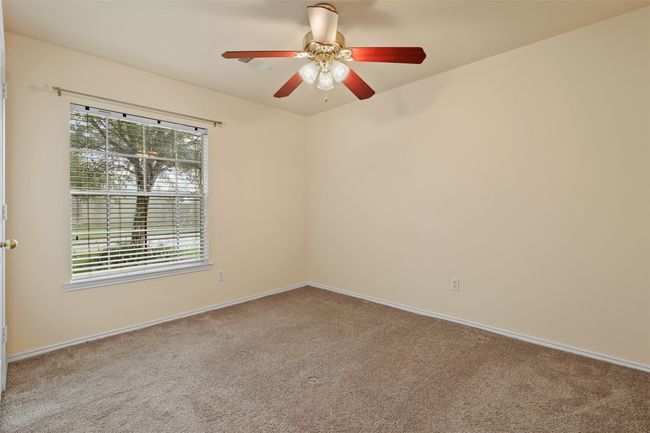 Additional secondary bedroom features carpet, ceiling fan, picture window and walk in closet. | Image 19