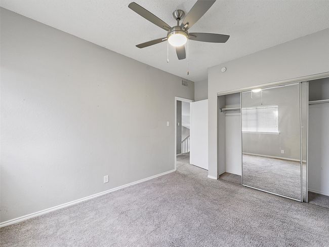 Bedroom with carpet & mirrored closet. | Image 25
