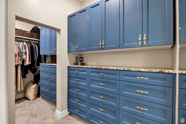 Walk in closet featuring light carpet | Image 40