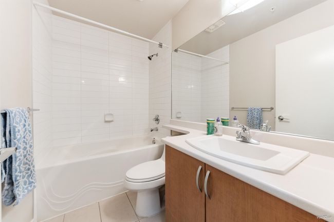 Bathroom featuring shower / bath combination, vanity, and light tile patterned floors | Image 12