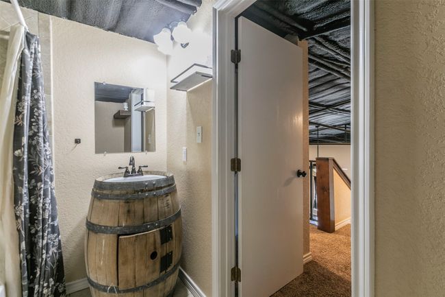 Bathroom featuring vanity and a textured wall | Image 26