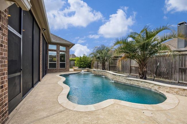 Backyard with Private Pool, Hot Tub, Fire pit and screened in patio. | Image 32
