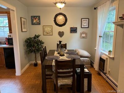 Dining room with baseboard heating and parquet floors | Image 3