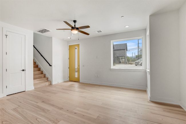 Spare room featuring light wood-style floors, stairway, a ceiling fan, baseboards, and recessed lighting | Image 10