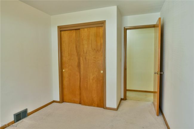 Unfurnished bedroom with baseboards, carpet flooring, visible vents, and a closet | Image 24