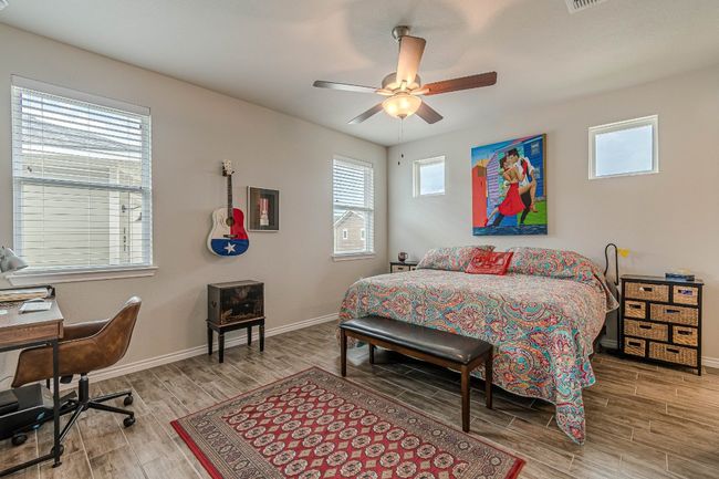 Bedroom with wood finished floors and a ceiling fan | Image 16