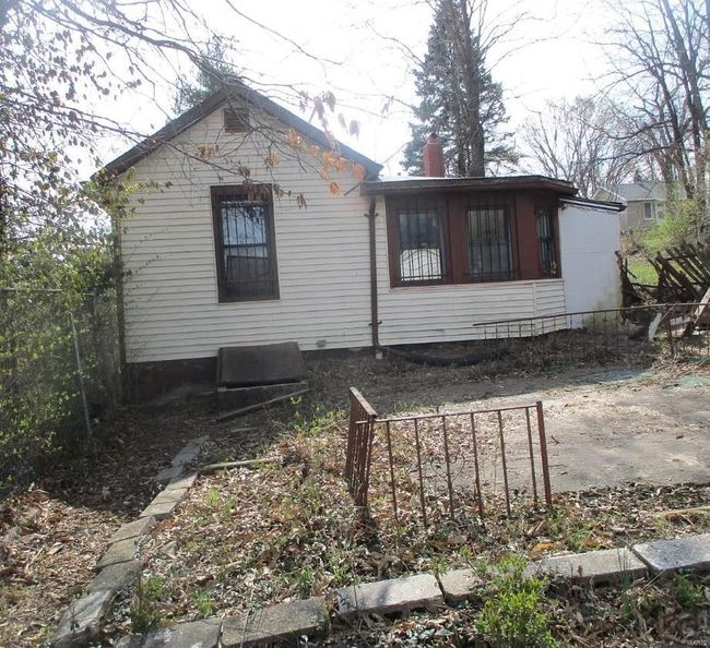 Back of house with a chimney and fence | Image 4