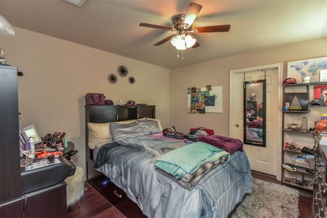 Bedroom featuring dark hardwood / wood-style flooring and ceiling fan | Image 12
