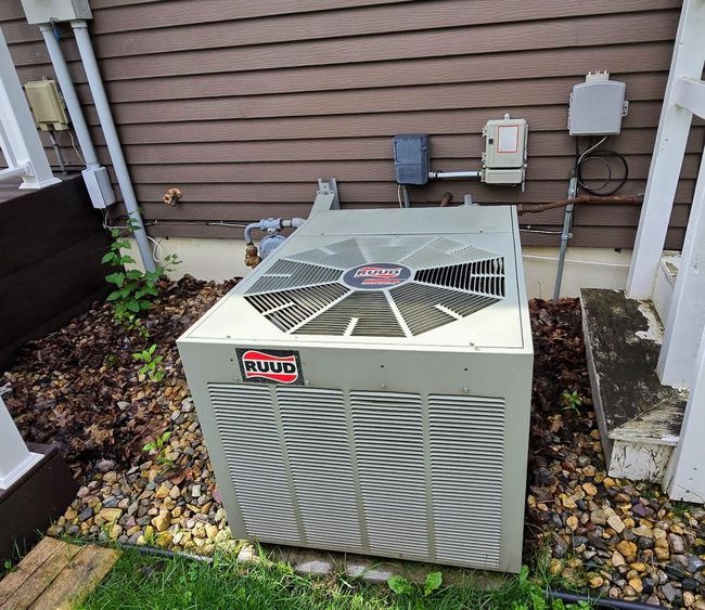 Ruud central air unit located on north side of house by deck | Image 52