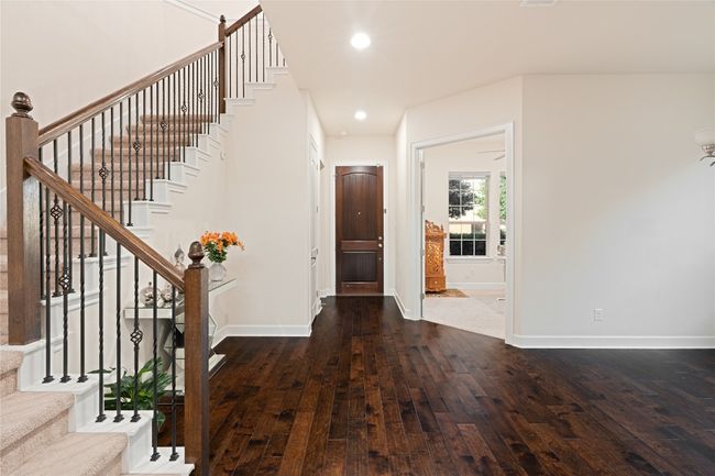 Entryway with dark wood finished floors, stairs, and recessed lighting | Image 6