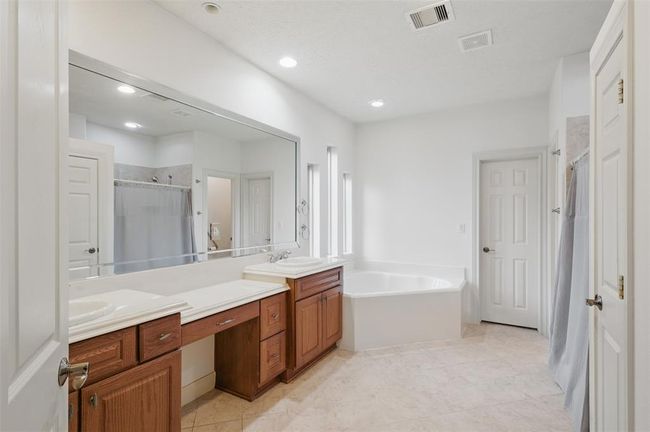 Large primary bathroom with double sinks, jetted tub and walk in shower. | Image 26