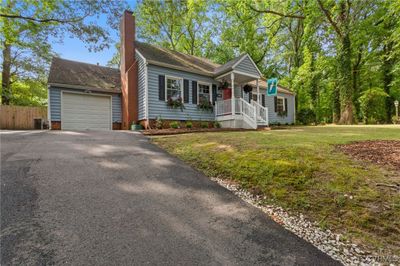 View of front of property featuring a garage, a porch, and a front yard | Image 3