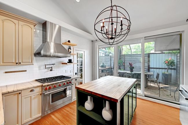 Kitchen featuring vaulted ceiling, Quartzite countertops, Wolf 6-burner range, pot-filler | Image 10