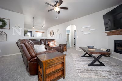 Living room with light carpet and ceiling fan | Image 3