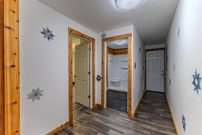 Hallway with dark wood-type flooring and baseboards | Image 29