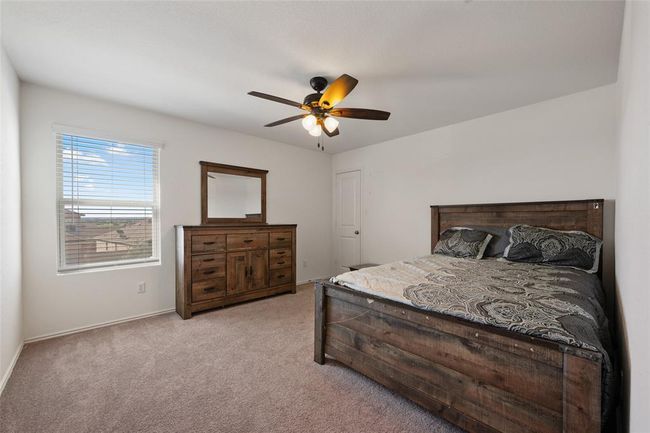Bedroom featuring light carpet, ceiling fan, and baseboards | Image 19