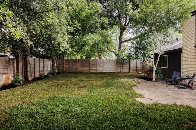 Fenced backyard with a patio | Image 34